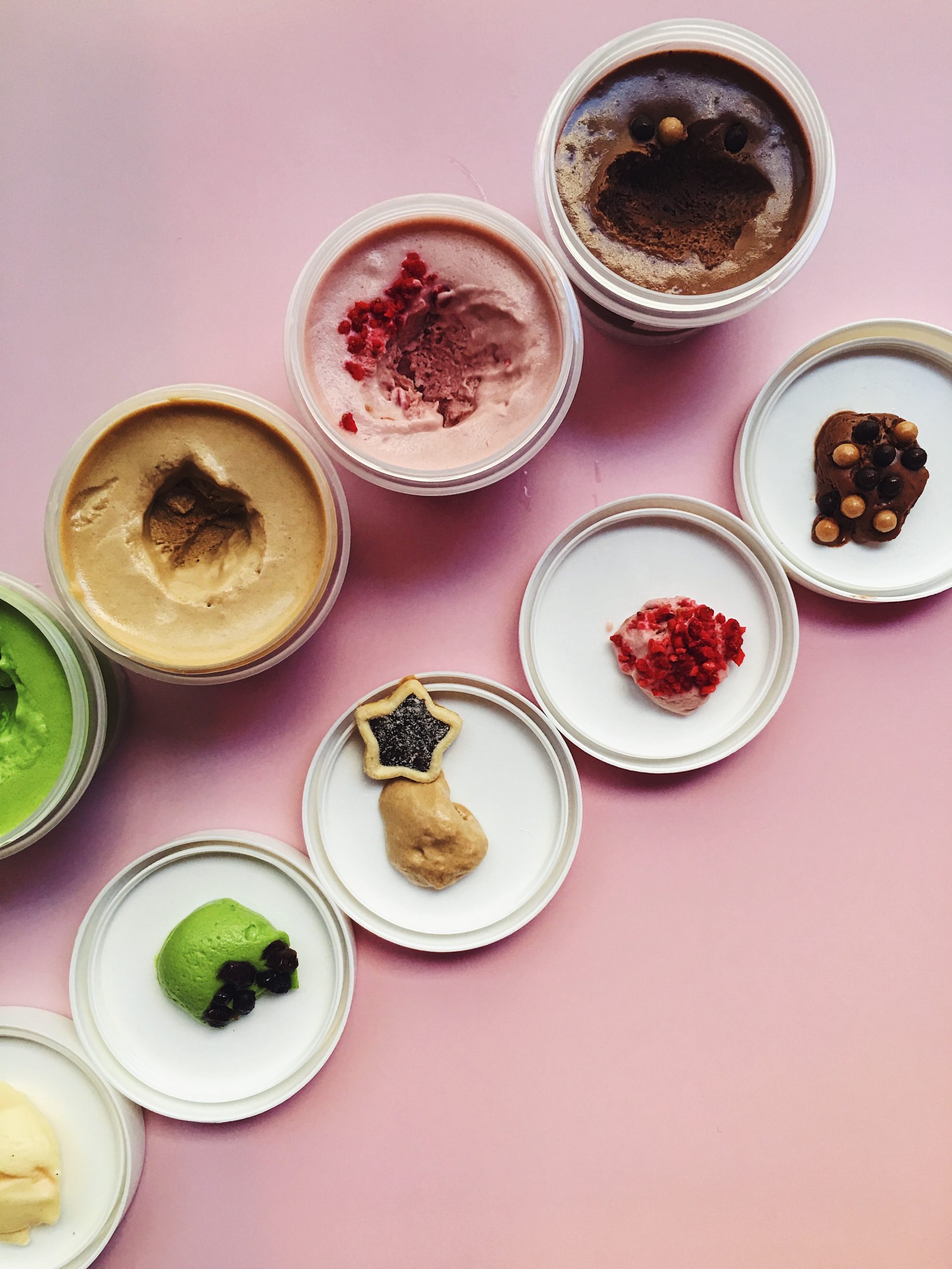 Bird's eye view of dessert jars lined up with accompanying lids with samples from each jar
