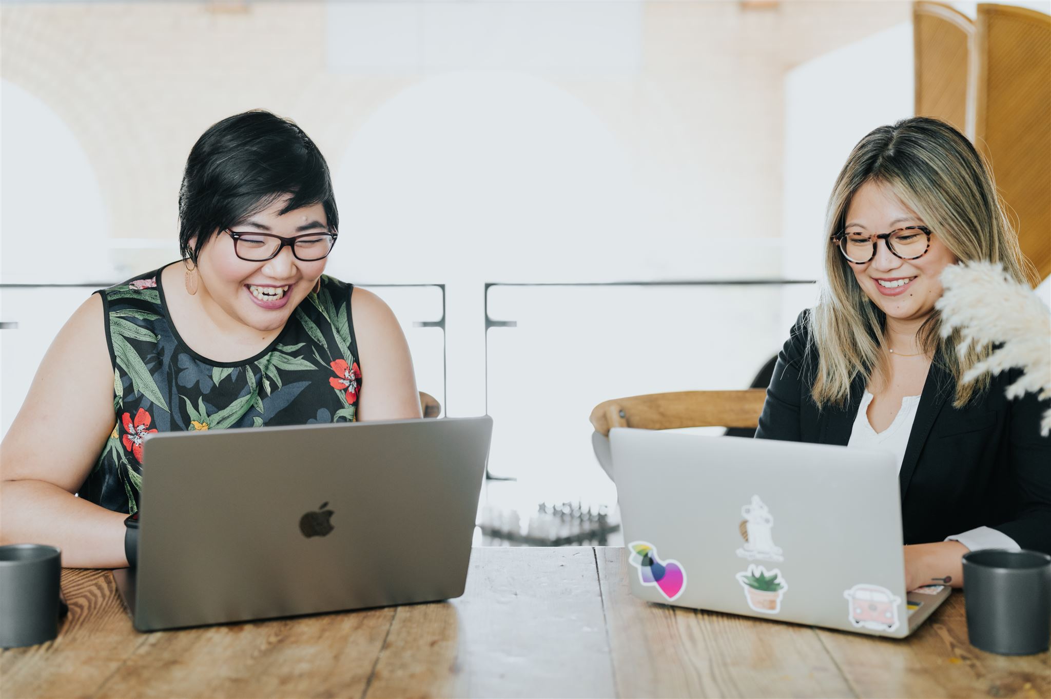 Romina Gets Branded Two asian woman sitting side by side on their laptops